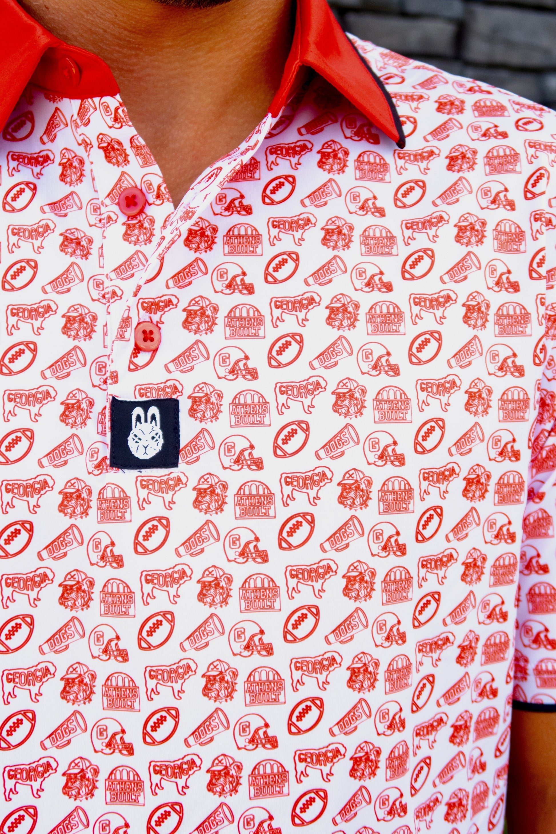 Close-up of the Saturdays in Athens Georgia inspired golf polo by Foresome Golf Co. showing fabric and logo.