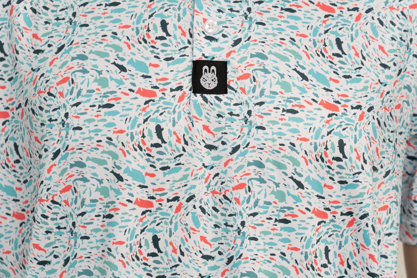 Close-up of button placket, showing structured neckline and subtle branding on the Fish 'n' Chips golf shirt.