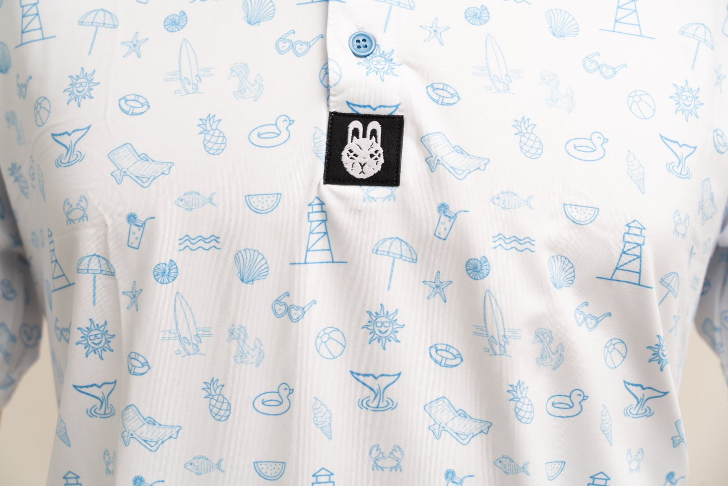 Close-up of beach-themed design on Fore-Shore Vibes golf polo showing palm print and high-quality finish