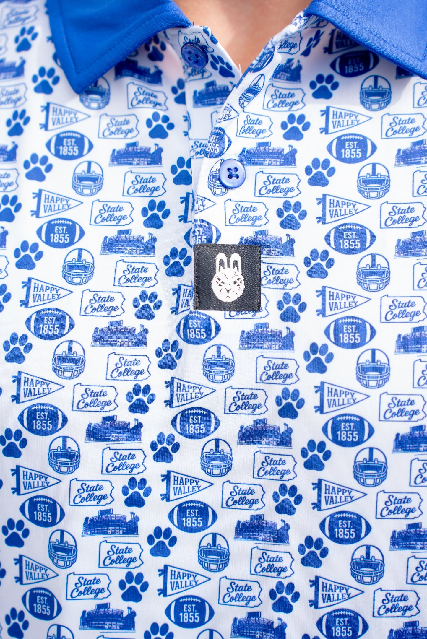 Close-up of the Saturdays in Happy Valley Penn State inspired golf polo by Foresome Golf Co. showing fabric and logo.