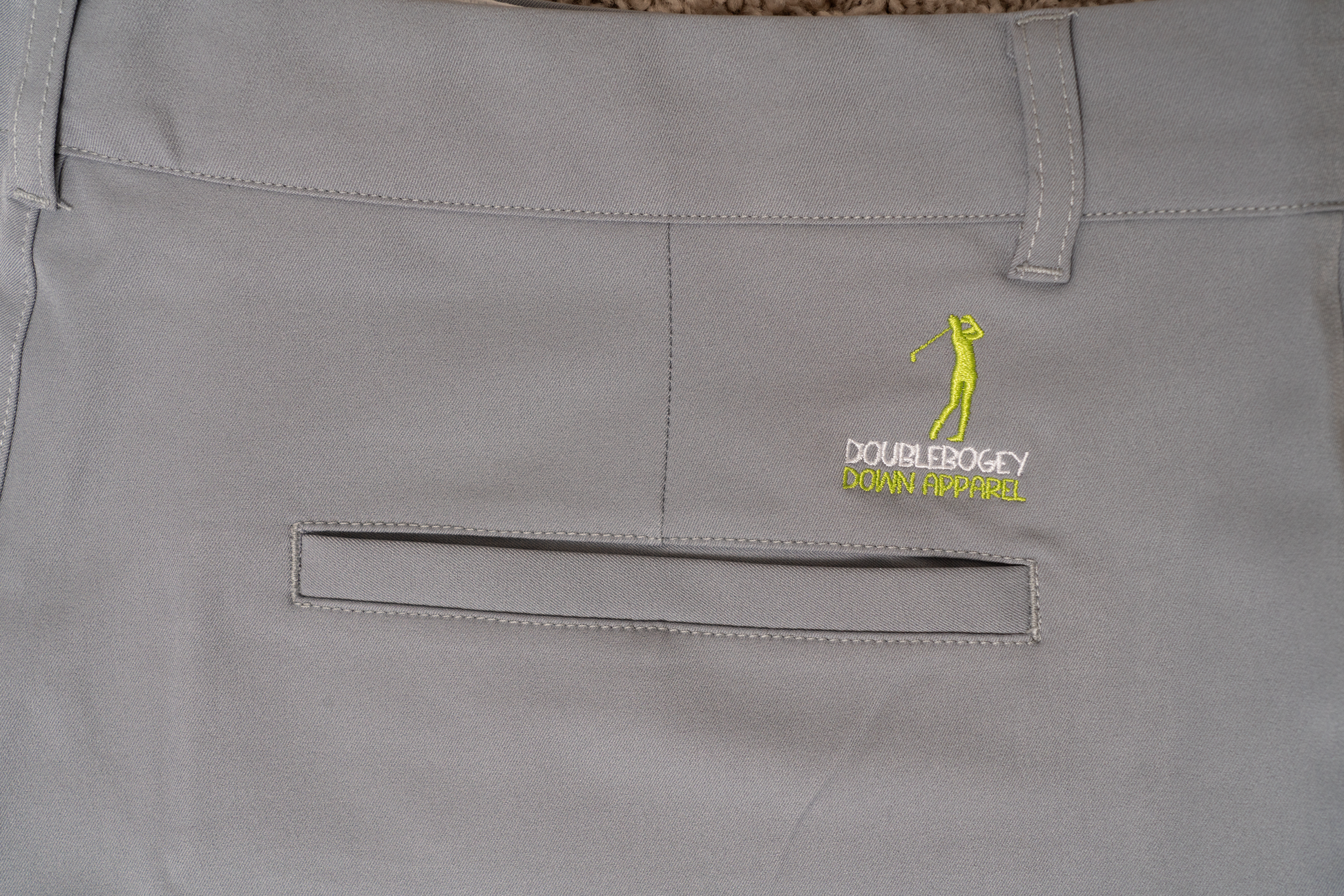 Back detail of The Fairway Fog golf shorts – smooth gray finish with secure pocket stitching and stretch waistband for flexible movement during play.