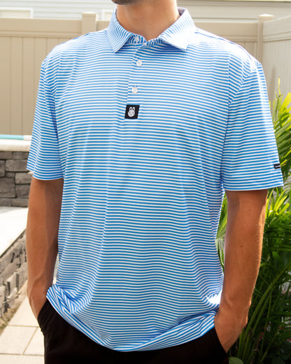 Man wearing The Captain Ron men’s golf polo in a relaxed, untucked fit with blue and white stripes