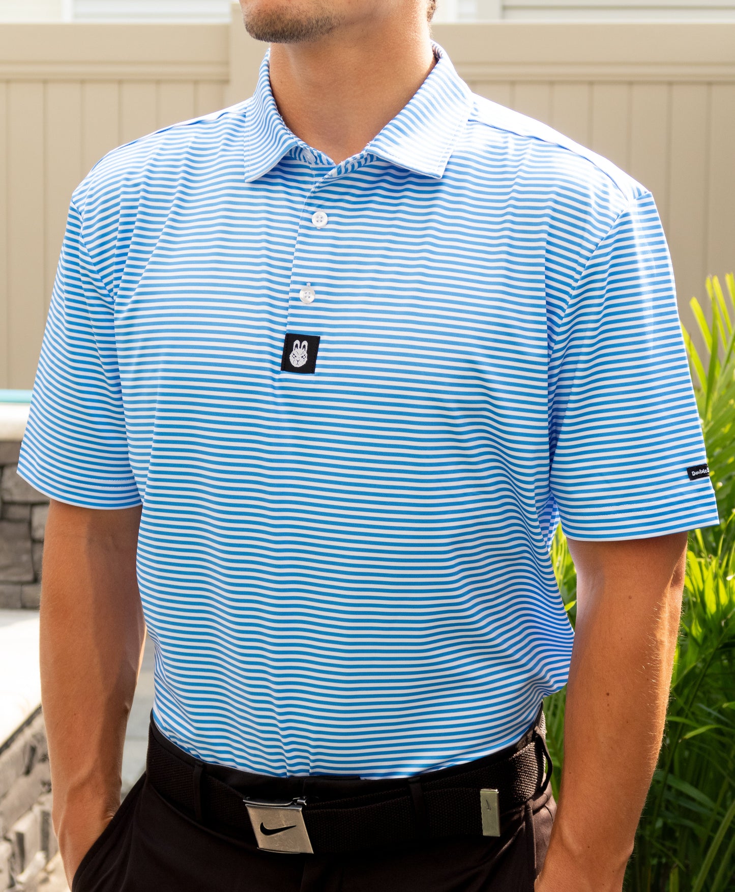Man wearing The Captain Ron men’s golf polo tucked in, showcasing a clean, nautical golf style