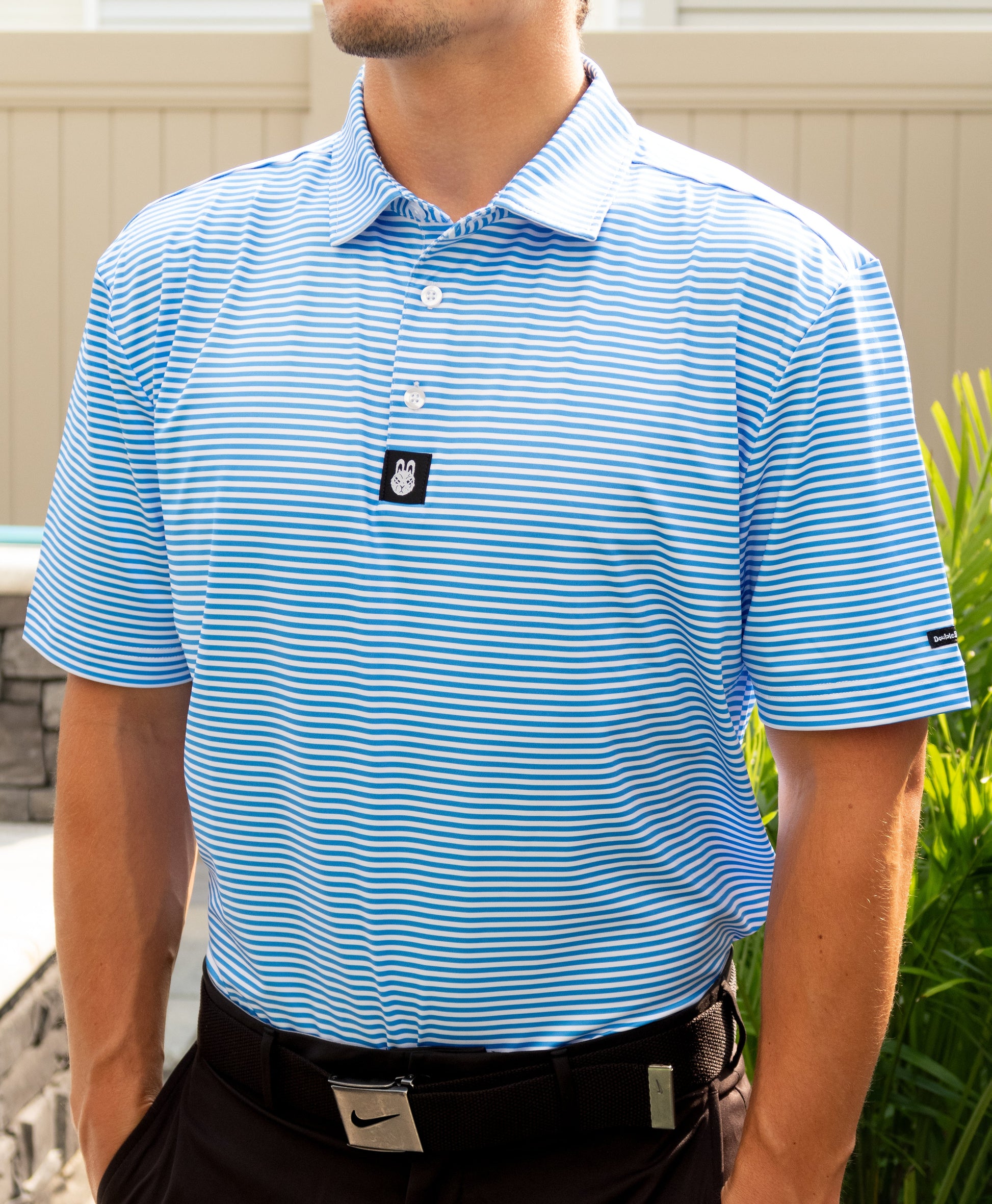 Man wearing The Captain Ron men’s golf polo tucked in, showcasing a clean, nautical golf style